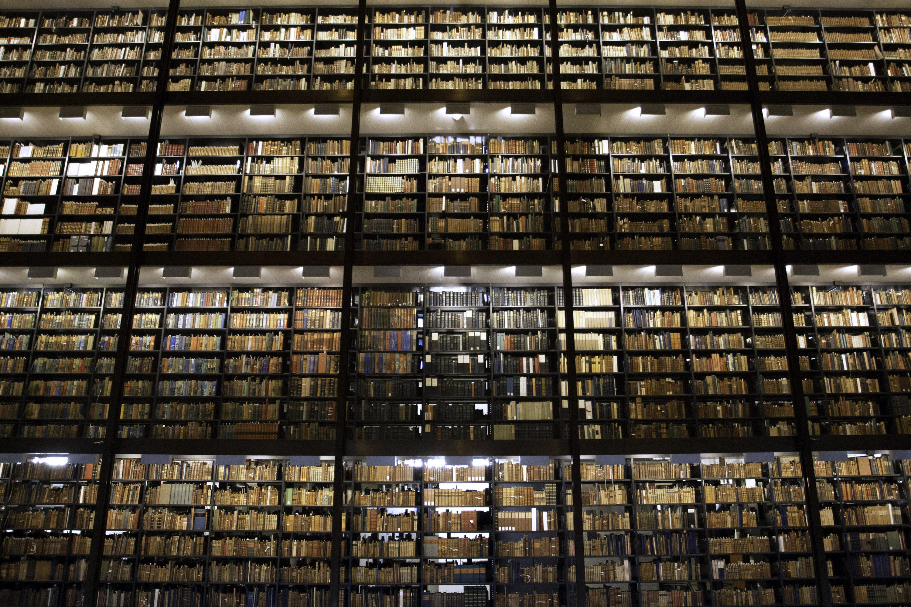 towering shelves of books in Beinecke Library