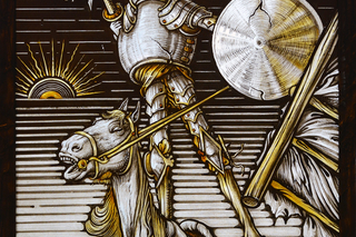 Detailed and dramatic stained glass depiction of Don Quixote